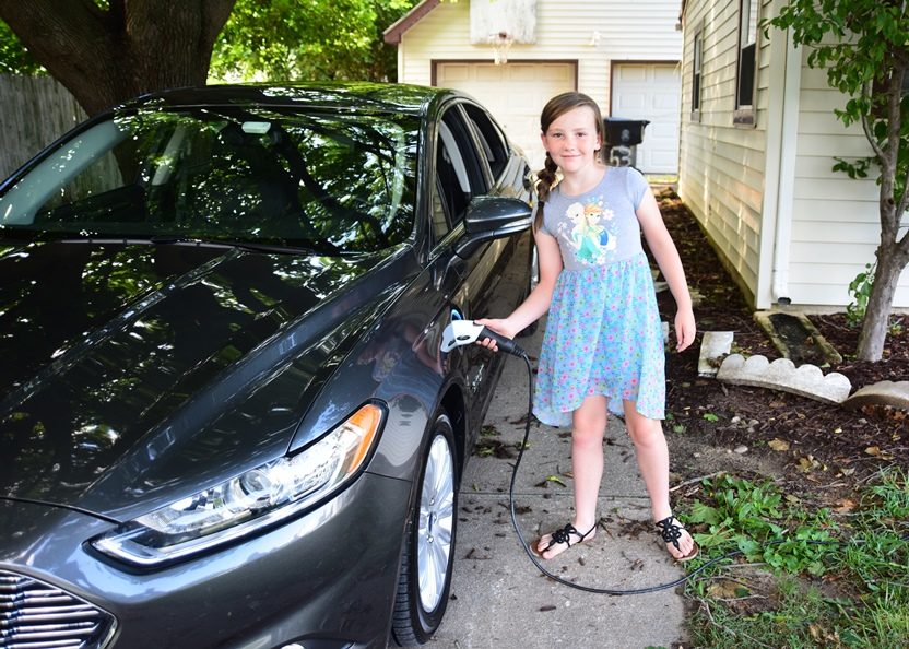 Girl Charges Electric Vehicle